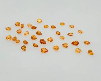 13 ctw of mixed size spessartite garnet gemstones. Most are pear cut.