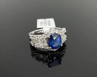 14K white gold size 7 ring stamped "Orianne". Mounted with (1) genuine GIA certified oval cut 3.22 ct sapphire center stone with (30) round diamonds (1.72 ctw) surrounding and on either side of the center stone. 6 gtw. Includes appraisal dated March 18, 2025 by American International Gemological Laboratories Inc. Appraisal provided by consigner. 