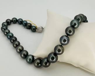 GIA certified single strand cultured Tahitian pearl 18" necklace. Each of the (35) pearls is individually hand knotted. Necklace is finished with a 14K white gold plunger style tension locking scalloped bead clasp. 84.1 gtw. Includes appraisal dated October 27, 2025 by American International Gemological Laboratories Inc. Appraisal provided by consigner.