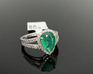 Platinum size 7 ring with a 2.17 ct pear cut natural emerald at the center. (50) round cut diamonds, 0.65 ctw, surround the center stone. 6 gtw. Includes appraisal dated June 5, 2024 by GemAssure Gemological Appraisals. Appraisal provided by consigner. 