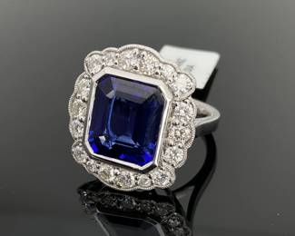Platinum size 6.75 ring with a 7.33 ct octagonal step cut blue violet tanzanite at the center. (18) Round brilliant cut diamonds accent around the center stone. 13.4 gtw. Includes appraisal dated November 17, 2023 by GemAssure Gemological Appraisals. Appraisal provided by consigner.