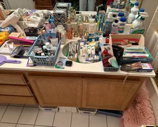 Bathroom items include pink, fluffy rugs, make up new toothbrushes and package, perfume samples, lots of travel items, salon series, folding hairdryer, curling irons, flat irons, etc.