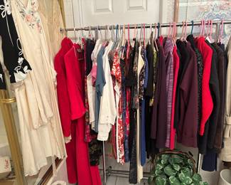 One of four clothing  racks or closets of hanging clothes, this one with robes and nightgowns, dresses, jackets, coats, longer, skirts, etc.