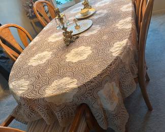 The table shown with tablecloth and one leaf inserted