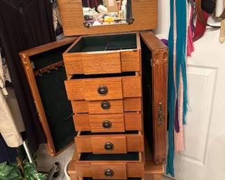 Jewelry chest,  jewelry armoire shown open for necklaces on each side drawers with different compartments and lift up top with mirror