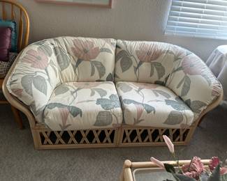 One of two bamboo rattan love seats