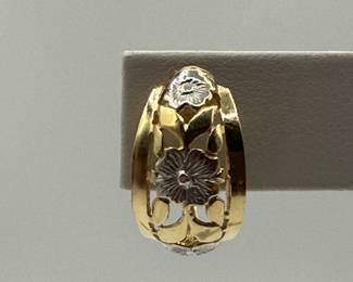 This is a pair of artfully designed half round hoops with attached clip back. The design features a yellow gold filagree with white gold flowers. These earrings are an excellent addition to any jewelry wardrobe and you can't go wrong with the value and durability of gold. 

Earrings come in a beautiful velvet gift box for gift giving. 