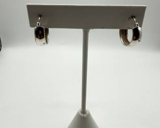 This is a pair of high polish hoop earrings 1/2 cm wide and in excellent condition. This set of classic hoops is a must for the distinguished jewelry wardrobe. Perfect for dressing up or every day wear. Earrings weigh .086 ozt and come in a beautiful box for gifting.  