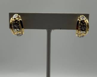 This is a pair of artfully designed half round hoops with attached clip back. The design features a yellow gold filagree with white gold flowers. These earrings are an excellent addition to any jewelry wardrobe and you can't go wrong with the value and durability of gold. 

Earrings come in a beautiful velvet gift box for gift giving. 