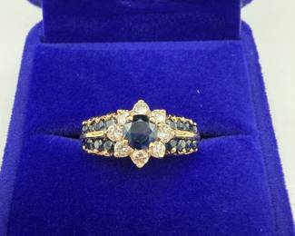 This gorgeous ring has a vibrant sapphire center stone surrounded by eight sparkling round cut diamonds all set in polished 14K gold. The ring is a size 7 1/2 and is ready to be gifted. Stones display a lovely fluorescence and the ring weights .151 ozt total with stones. Don't let this beauty slip away! Beautiful gift box included for your own storage or gifting. 