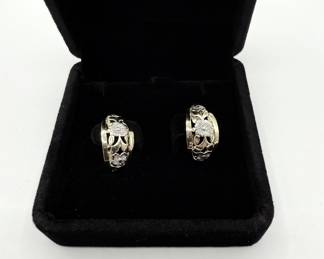 This is a pair of artfully designed half round hoops with attached clip back. The design features a yellow gold filagree with white gold flowers. These earrings are an excellent addition to any jewelry wardrobe and you can't go wrong with the value and durability of gold. 

Earrings come in a beautiful velvet gift box for gift giving. 