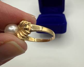 This is a beautiful classic pearl ring nestled in a 14K gold ribbon setting with two diamonds that have beautify fluorescence. This is a statement piece for any jewelry wardrobe. Size 7 1/2 and a total weight of .145 ozt with the pearl and diamonds. Beautiful gift box included for your own use or gifting. 