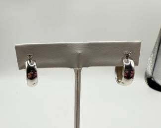 This is a pair of high polish hoop earrings 1/2 cm wide and in excellent condition. This set of classic hoops is a must for the distinguished jewelry wardrobe. Perfect for dressing up or every day wear. Earrings weigh .086 ozt and come in a beautiful box for gifting.  