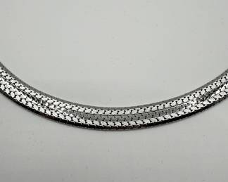 This sterling silver choker has a beautiful woven design and is in beautiful condition. 16 1/2" length is perfect for every day wear or to add some shine for more formal events. A total of 1.134 ozt makes this a great investment piece. 