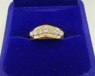 This is a stunning 14 karat gold and diamond ring with a lovely bridge setting that includes a total of seven diamonds. With .139 Troy ounces of gold and seven diamonds with lovely fluorescence, this is both a great gift and an investment piece. Diamonds show lovely fluorescence. Gift box is included for your storage or gift giving. 

