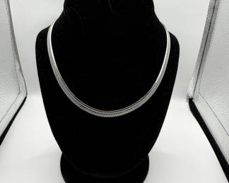 This sterling silver choker has a beautiful woven design and is in beautiful condition. 16 1/2" length is perfect for every day wear or to add some shine for more formal events. A total of 1.134 ozt makes this a great investment piece. 