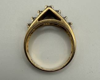 This is a stunning 14 karat gold and diamond ring with a lovely bridge setting that includes a total of seven diamonds. With .139 Troy ounces of gold and seven diamonds with lovely fluorescence, this is both a great gift and an investment piece. Diamonds show lovely fluorescence. Gift box is included for your storage or gift giving. 

