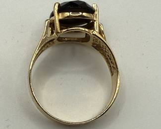 This is a 14K gold ring with an oval black stone, likely onyx. Stone is opaque and set in 14K gold. Ring weighs .12 ozt with stone and comes in lovely gift box for your own storage or gift giving. 