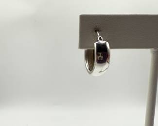 This is a pair of high polish hoop earrings 1/2 cm wide and in excellent condition. This set of classic hoops is a must for the distinguished jewelry wardrobe. Perfect for dressing up or every day wear. Earrings weigh .086 ozt and come in a beautiful box for gifting.  