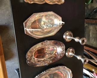 Various vintage silver platters and candlesticks
