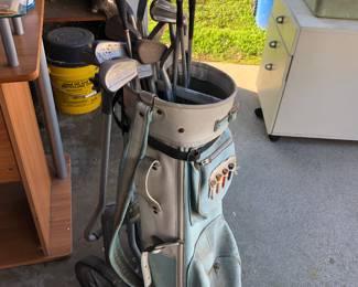 Golf clubs, bag, and cart