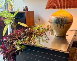 Mid-Century Modern Planter Table, c. 1965–1975
Lacquered wood and brushed steel with integrated planter
A striking Mid-Century Modern planter/coffee table featuring a recessed center planting trough framed within a brushed-steel top. The rectilinear form is supported by a black lacquered base with chrome-style horizontal trim lines, characteristic of late-1960s American modernist style. A functional and sculptural design object that allows greenery to become part of the furniture experience.
This form is closely associated with the era’s interest in indoor landscapes and biophilic environments, making it both a collectible period piece and a highly practical design element for contemporary living.