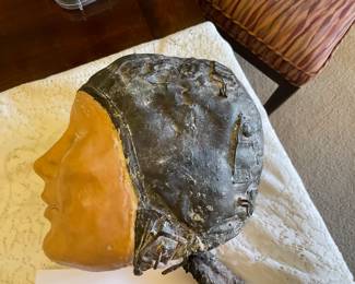 We think this is Amelia Earhart, pottery and metal sculpture