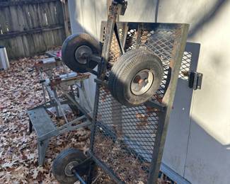 Metal cart in back yard on right - metal stand on left 