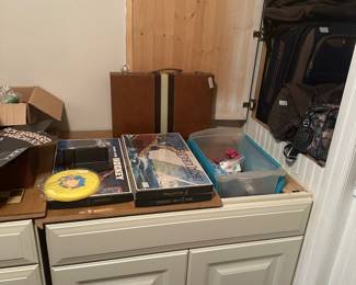 More sit cases to tight in cabinet - briefcase & miscellaneous on cabinet top 