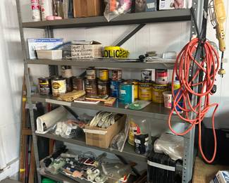 Garage - shelves + lots of paint, brushes, gloves, plastic sheeting, supplies and boxed items 