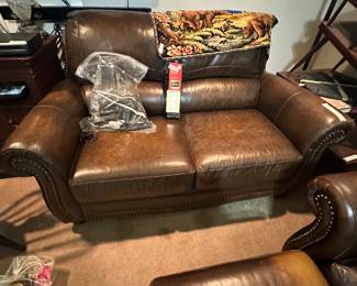Leather love seat - TV in background 