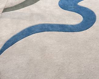Oval rug with blue and gray ribbon design