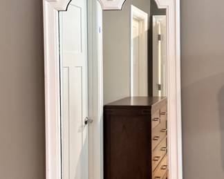 Narrow white hanging wall mirror with scroll top