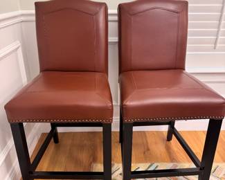 Pair of leather counter stools with nailhead trim