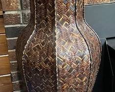 Woven wicker floor vase.
