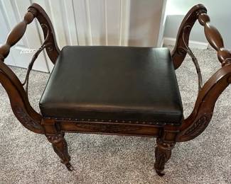 Decorative wooden chess table with built-in board and upholstered seat.