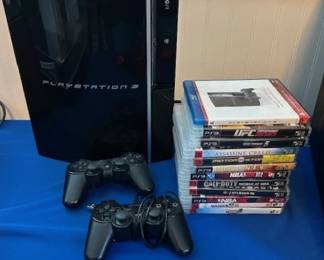 Sony Play-Station 3 (PS3) Super Slim home console with controllers and several games.