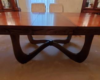 Mid-century dining mahogany has 6 matchingchairs and a 2 pc china cabinet.