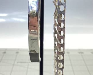 2 STERLING SILVER BRACELET LOT A TAXCO CARTIER STYLE LOVE BANGLE AND SQUARE CURB LINK BRACELET. BANGLE 2.5 INCH DIAMETER, CURB LINK 9 INCHES LONG. TOTAL WEIGHT 27.57 GRAMS