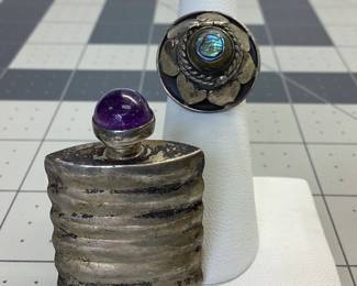 VTG POISON RING AND PERFUME BOTTLE THESE ARE MADE OF STERLING SILVER. POISON RING FEATURES ABALONE, SECRET COMPARTMENT AND ADJUSTABLE SIZE. THE PERFUME OR SNUFF BOTTLE FEATURES A CABOCHON AMETHYST ON THE TOPPER. TOTAL WEIGHT IS 17.03 GRAMS. PATINA HAS BEEN LEFT TO PRESERVE PIECES.