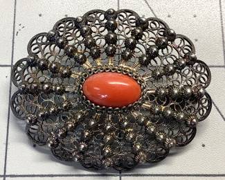 VTG ART NOUVEAU SILVER, RED CORAL BROOCH STAMPED 800 (80%) SILVER ANTIQUE FILIGREE BROOCH FEATURES CABOCHON RED CORAL. WEIGHT IS 9.86 GRAMS. PATINA IS LEFT TO PRESERVE PIECE.