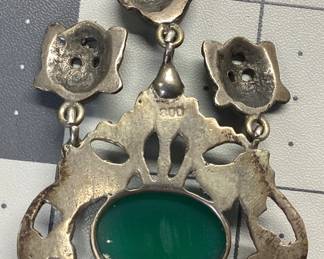 ANTIQUE SILVER JEWELRY LOT EARLY 20TH CENTURY COMMEDIA DELL'ARTE RENAISSANCE REVIVAL PENDANT (POSSIBLE PERUZZI OR COPPINI DESIGNED) SET IN 800(80%) SILVER FEATURING A CABOCHON CHRYSOPRASE. THE ANTIQUE PIECE IS HUNG FROM A 24 INCH STERLING BOX LINK CHAIN. WEIGHT 26.56 GRAMS. ALSO AN ANTIQUE STERLING SCRIMSHAW RING WITH LIONS HEAD ETCHING. WEIGHT IS 9.42 GRAMS, SIZE 6.5. RING HAS SIGNS OF AGE AROUND THE OUTER DIAMETER. PATINA HAS BEEN KEPT TO PRESERVE THESE PIECES