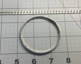 2 STERLING SILVER BRACELET LOT A TAXCO CARTIER STYLE LOVE BANGLE AND SQUARE CURB LINK BRACELET. BANGLE 2.5 INCH DIAMETER, CURB LINK 9 INCHES LONG. TOTAL WEIGHT 27.57 GRAMS