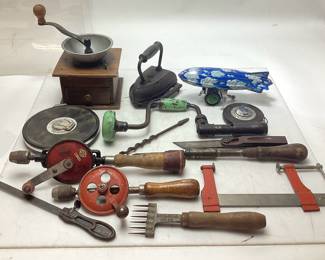 ASSORTED COLLECTIBLES, 1900s COFFEE GRINDER, SAD IRON & TRIVET, SCHYLLING STEALTH ZEPPELIN TIN WIND-UP TOY, KESON FIBERGLASS MEASURE TAPE, CHROME CLAD STEEL MEASURE TAPE, BRIDDELL ICE PICK, BOX CUTTER, STANLEY, EGGBEATER DRILLS, VTG. TOOLS NO SHIPPING PICKUP ONLY