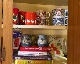 Assortment of cookbooks and coffee mugs
