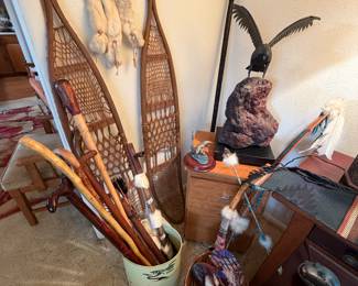 Vintage snowshoes circa 1940s, variety of carved wooden walking sticks, dream catcher made of deerskin, feathers and beads, African tribal throwing spear