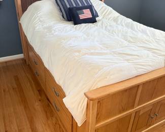 Qak Queen platform bed with storage drawers and cabinet.  Headboard also has storage area.  Queen down duvet and linens