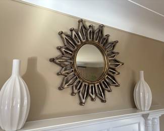 Starburst mirror and white ceramic vases