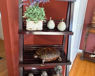 Tiered bookcase and decor:  faux lavender plants (2), ceramic pears, turtle, and set of 3 urns