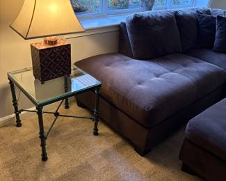 Another view of the sectional and side table - metal and glass and shown with porcelain red lamp